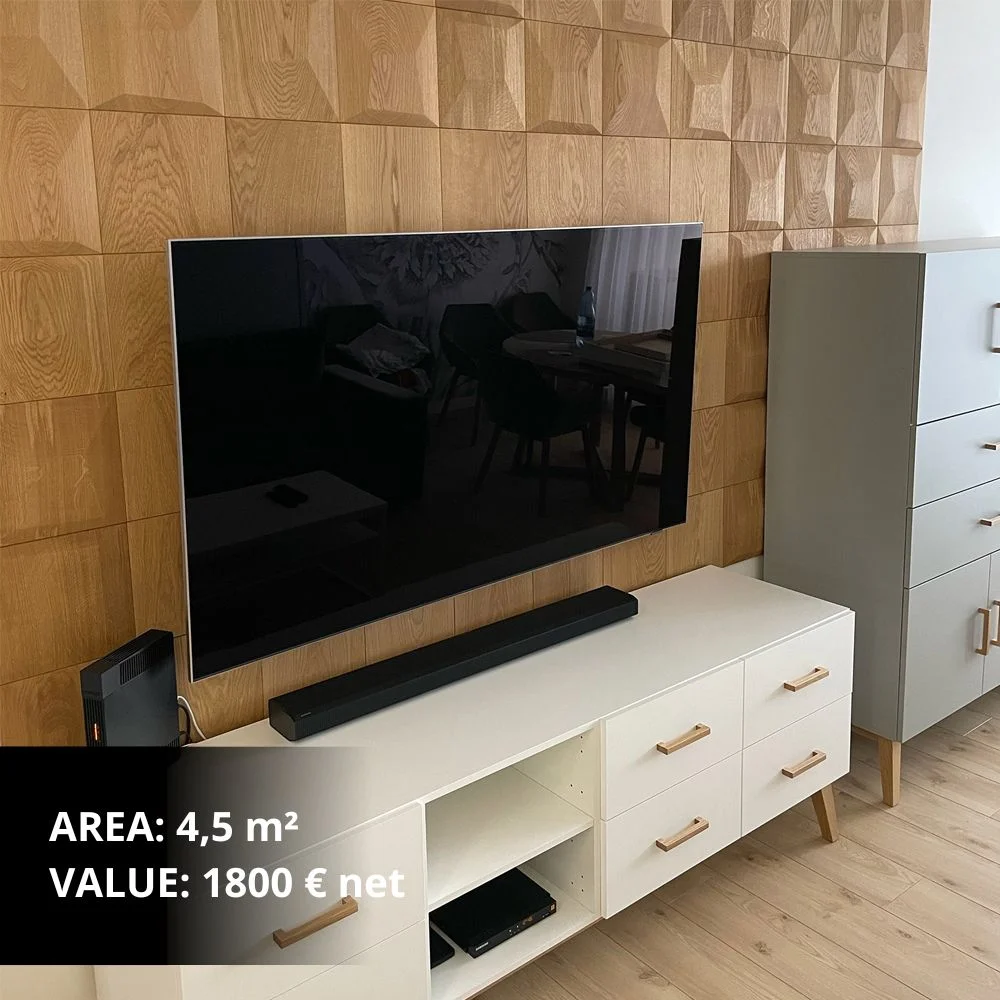Modern TV accent wall featuring 3D oak wood panels with a pillow pattern, paired with a white Scandinavian-style media console.