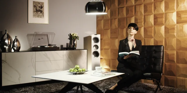 Luxury living room featuring a 3D oak square pattern wall, with a turntable, modern speaker, and stylish ambient lighting.