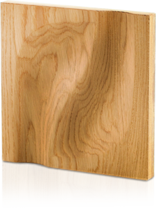 A studio product shot on a black background showing a single square Impressions collection 3D wooden panel made of natural oak with an organic concave relief, showcasing rich wood grain and plywood backing.